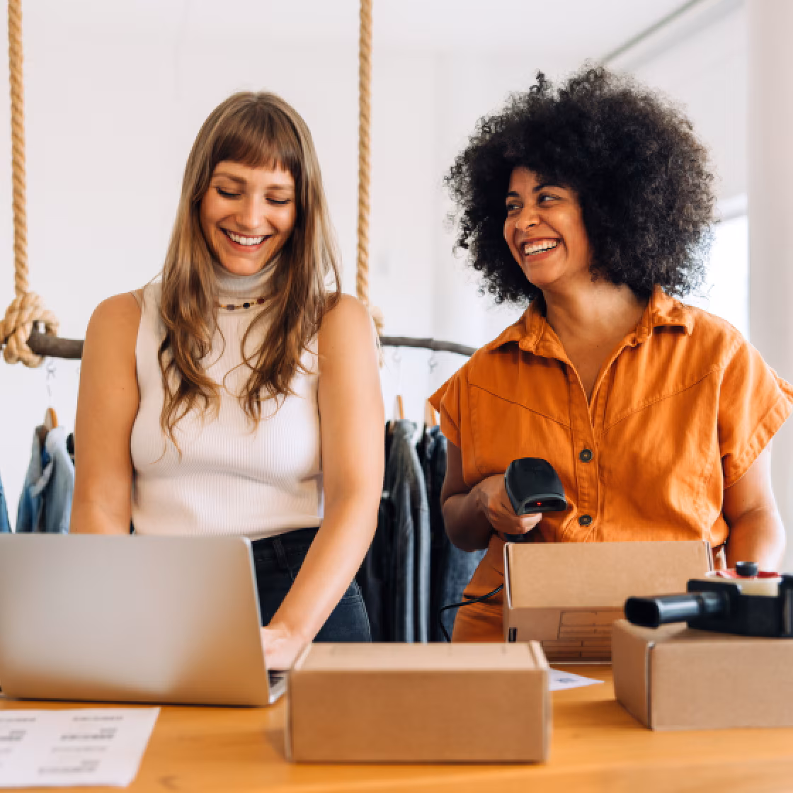 two women looking at computer and smiling